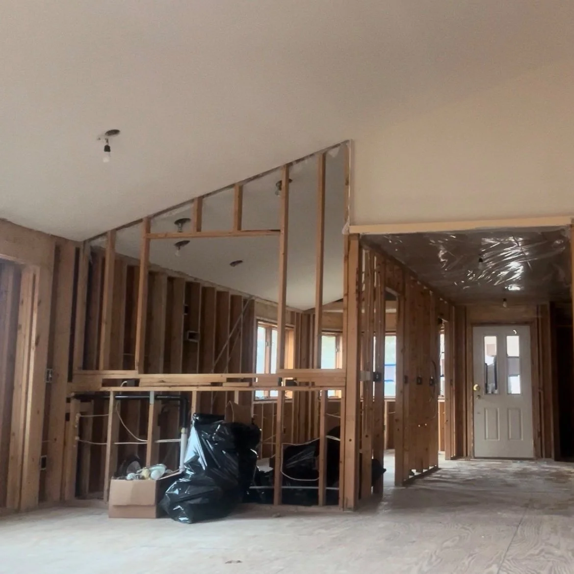 Home interior with exposed wood framing and open walls before drywall