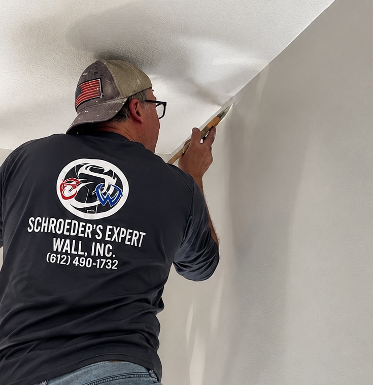 Schroeder's Expert Wall painter rolling a smooth, even coat on an interior wall