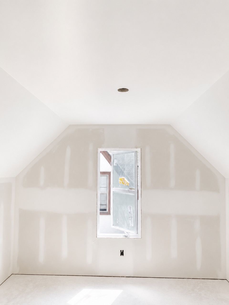Custom drywall hung, taped, and finished smooth around a feature window