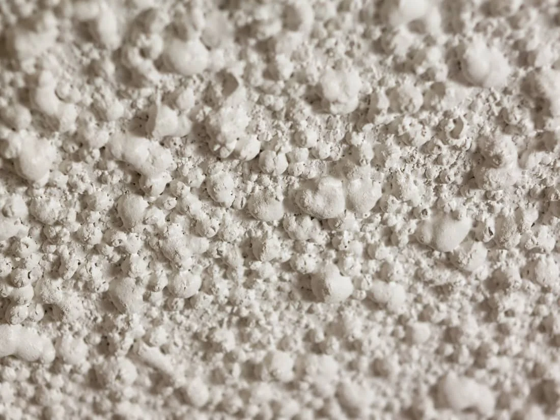 Existing popcorn ceiling texture seen from below, the texture we typically remove
