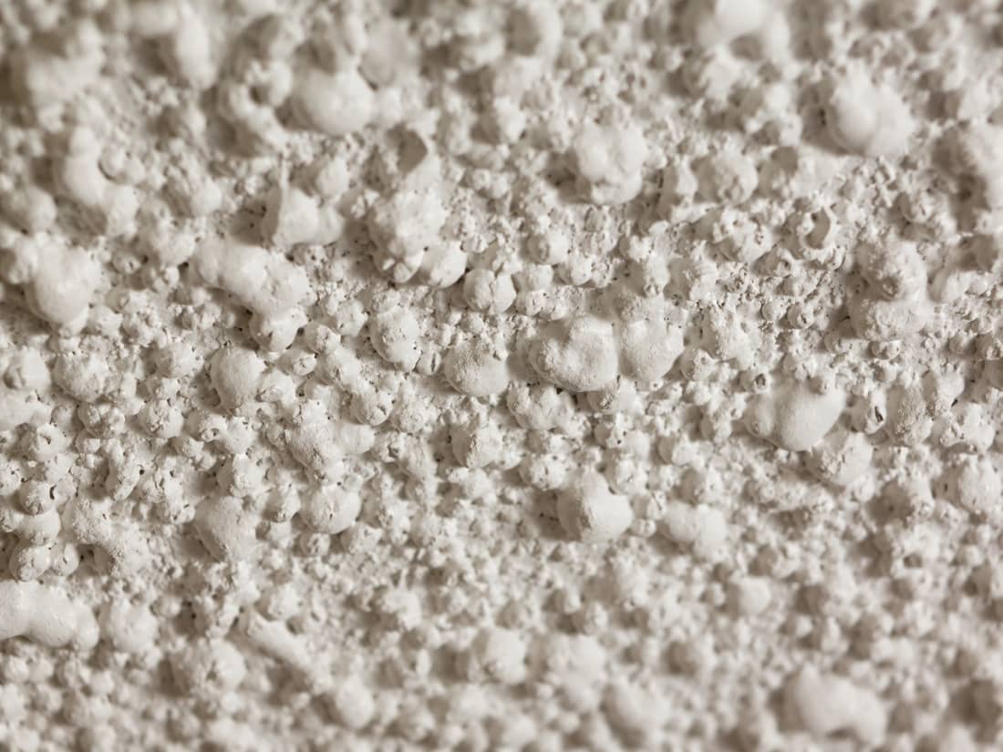 Existing popcorn ceiling texture seen from below, the texture we typically remove