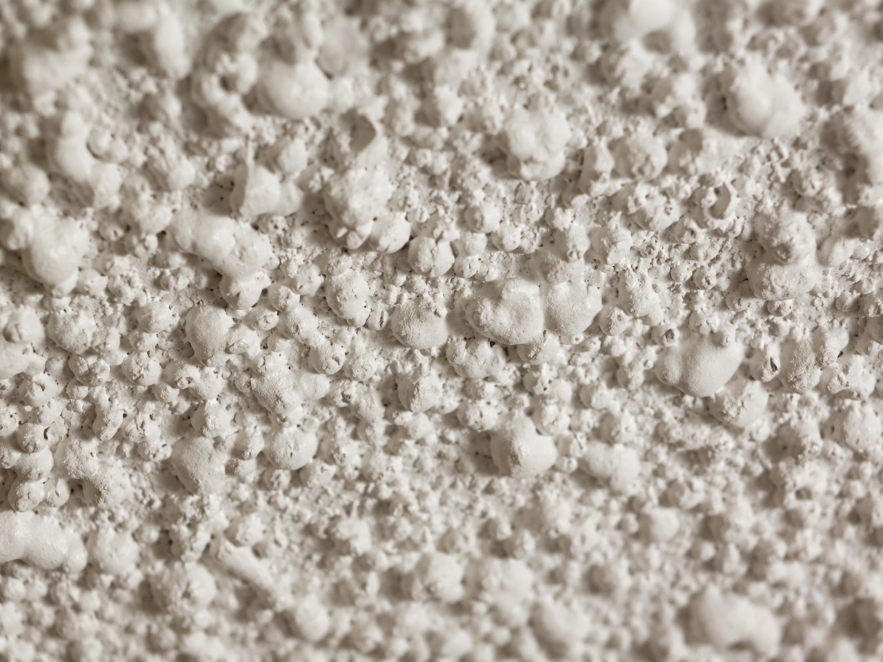 Existing popcorn ceiling texture seen from below, the texture we typically remove